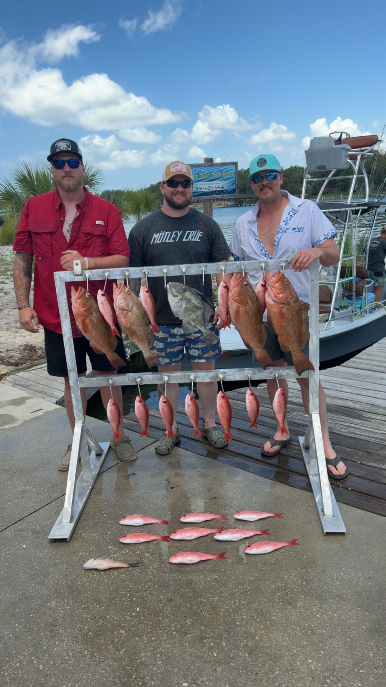 Three guests beside a mixed catch from an earlier trip
