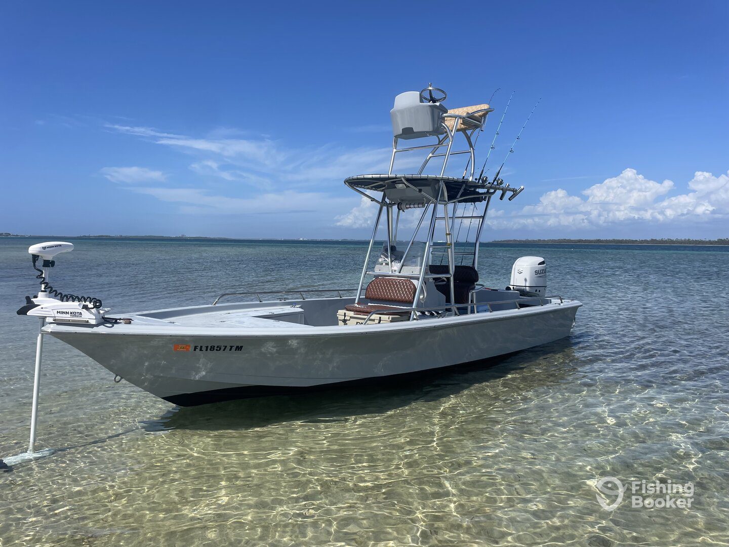 Side view of the Gulf Coast Guide Fishing boat anchored in clear shallow water